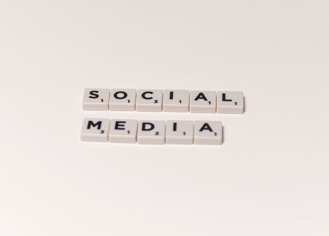 home-hero-bg Scrabble tiles spelling social media on a white background, representing digital communication concepts.
